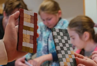 Ausstellung Lokschuppen Rosenheim Römer 2026 207 Workshop Kinderhände mit Mosaik © VKR